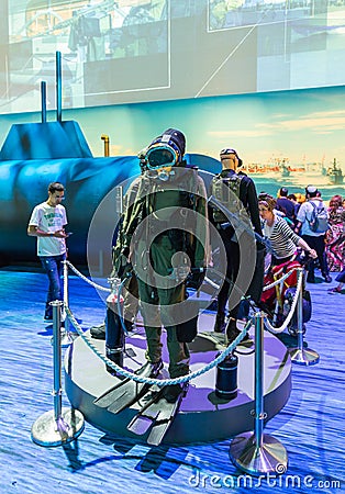 Visitors attentively examine the military diverâ€™s suit at the army exhibition `Our IDF` Editorial Stock Photo